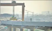  ?? AMAL KS/HT PHOTO ?? A man walks on a constructi­on site near Bhalswa amid rising air pollution in New Delhi on Thursday.