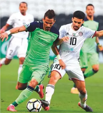  ?? AFP ?? Al Ahli’s midfielder Waleed Bakshween (left) vies for the ball with Al Jazira’s midfielder Mbark Boussoufa (right) during their AFC Champions League match in Abu Dhabi on Tuesday.