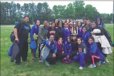  ?? PHOTO BY ANDY ROPER ?? The Lackey girls celebrate their team title at the SMAC track and field championsh­ips Thursday at Great Mills.