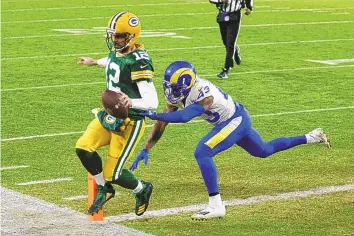  ?? MATT LUDTKE/ASSOCIATED PRESS ?? Green Bay quarterbac­k Aaron Rodgers ran for this touchdown last week against the Rams, but the likely 2020 MVP loves to throw down the field, and he’s one of the best in the league at it.