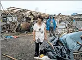  ?? JES AZNAR/GETTY ?? People inspect their damaged property Saturday in Alcala, Philippine­s, after typhoon Mangkhut made landfall.