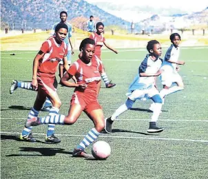  ?? ?? GIRLS’ SOCCER: Enoch Mgijima Local Football Associatio­n girls’ teams Sister’s Chant, in red and white, and Kaizer United, in action during a Women’s Month tournament on Sunday