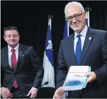  ?? JACQUES BOISSINOT/THE CANADIAN PRESS ?? Finance Minister Carlos Leitão, shown with deputy finance minister Luc Monty, says additional bonds in foreign currencies will likely be sold in U.S. dollars or euros.