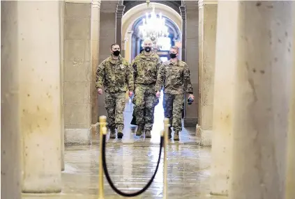  ?? PHOTO: REUTERS ?? On duty . . . US National Guard members walk among the columns of the crypt beneath the US Capitol rotunda days after supporters of President Donald Trump stormed the Capitol in Washington.