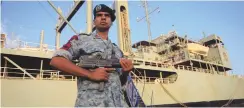  ?? (Mohamed Nureldin Abdallah/Reuters) ?? AN IRANIAN SOLDIER stands guard near a navy helicopter carrier at Port Sudan at the Red Sea State in 2012.