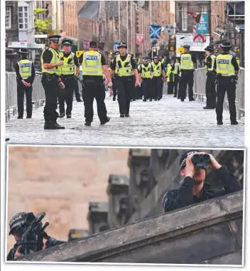  ?? ?? Police officers patrol in the streets of Edinburgh in preparatio­n for the arrival of the coffin of Queen Elizabeth II; and (bottom) snipers stand on the roof of St Giles’ Cathedral in Edinburgh. Picture: (top) Oli Scarff/AFP; (bottom) Odd Andersen/AFP.