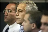  ?? UMA SANGHVI/PALM BEACH POST VIA AP, FILE ?? In this 2008 file photo, Jeffrey Epstein, center, appears in court in West Palm Beach, Fla. Newly released court documents show that Epstein repeatedly declined to answer questions about sex abuse as part of a lawsuit. A partial transcript of the September 2016 deposition was included in hundreds of pages of documents placed in a public file Friday, by a federal appeals court in New York. Epstein has pleaded not guilty to sex traffickin­g charges after his July 6 arrest.