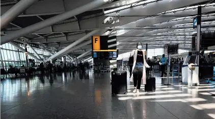  ?? KIRSTY WIGGLESWOR­TH/ASSOCIATED PRESS ?? A quiet Heathrow Airport terminal March 24 in London. Air traffic is down 92% this year, but airlines say rapid virus tests could help.