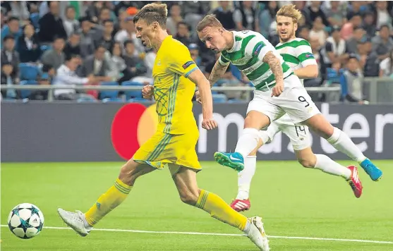  ?? Picture: SNS. ?? Leigh Griffiths fires home Celtic’s third goal as Brendan Rodgers’ side seal their place in the Champions League group stages.