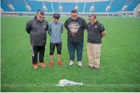  ?? AFP ?? Chinese fans of Beijing Enterprise­s player Cheick Tiote pay their respects after laying a bouquet. —