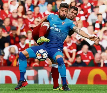  ?? — Reuters ?? No you don’t: Arsenal’s Olivier Giroud shielding the ball from Liverpool’s Dejan Lovren during the English Premier League match at Anfield on Sunday.