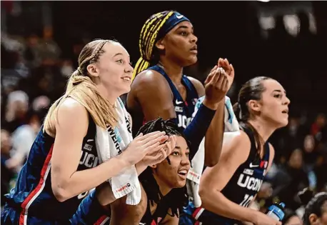 ?? Greg Fiume/Getty Images ?? Paige Bueckers, KK Arnold, Aaliyah Edwards and Nika Mühl celebrate in the fourth quarter of a win at Georgetown on Jan. 7. Bueckers, Edwards and Mühl will be honored as part of Friday’s Senior Night festivitie­s.
