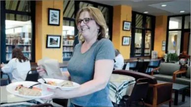  ?? ERICA Miller/emiller@saratogian.com ?? Kimberlie DeSilva, owner of Higher Grounds café in the Saratoga Springs Public Library, will retire in June.