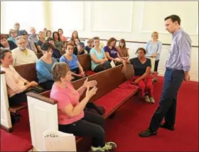  ?? PETE BANNAN – DIGITAL FIRST MEDIA ?? U.S. Congressma­n Ryan Costello, R-6th Dist., holds pop-up Town Hall meeting with 4045 protesters who have been gathering every Friday outside his West Chester office.
