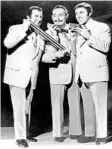  ?? ORLANDO SENTINEL FILE WALT DISNEY CO./ COURTESY ?? Right: Jerry Murad and the Harmonicat­s perform at Walt Disney World’s Top of the World supper club in October 1977.
Far right: Walt Disney World’s Top of the World band leader Harry West, standing first row. The band was composed of veterans of the Big Band Era.