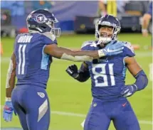  ?? AP PHOTO/MARK ZALESKI ?? Tennessee Titans tight end Jonnu Smith (81) is congratula­ted by wide receiver A.J. Brown after Smith caught a touchdown pass against the Buffalo Bills in the second half Tuesday.
