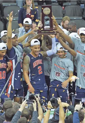  ?? DENNY MEDLEY/USA TODAY SPORTS ?? Auburn players celebrate winning the Midwest Regional and earning the school’s first trip to the men’s Final Four.