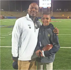  ??  ?? Navy offensive coordinato­r Ivin Jasper poses with his son, Jarren, who is waiting for a heart transplant. JASPER FAMILY PHOTO