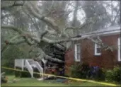  ?? CHUCK BURTON — THE ASSOCIATED PRESS ?? A fallen tree is shown after it crashed through the home where a woman and her baby were killed in Wilmington, N.C., after Hurricane Florence made landfall Friday.