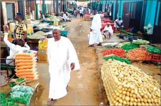  ?? AFP ?? Sudanese vendors sell vegetables in the central market of Khartoum on Monday. Protest leaders have agreed to end a campaign of civil disobedien­ce, an Ethiopian mediator said on Tuesday.