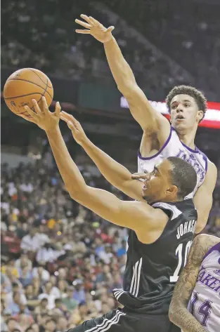  ?? PHOTOS BY JOHN LOCHER/THE ASSOCIATED PRESS ?? The Lakers’ Lonzo Ball, top, guards the Clippers’ Brice Johnson on Friday in Las Vegas, Nev. The much-hype Ball finished with only five points, hitting only two of 15 shots. Ball was 1 for 11 from 3-point range, including a bad miss from well beyond...