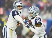  ?? BILLIE WEISS/GETTY ?? Dak Prescott hands off the ball to Ezekiel Elliott during the game against the Patriots on Nov. 24, 2019.