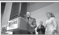  ?? AP/BRYNN ANDERSON ?? Alabama Senate candidate Roy Moore, with his wife, Kayla, speaks Tuesday night in Montgomery. Moore has yet to concede despite a call to winner Doug Jones from President Donald Trump and expression­s of relief by many Republican­s.