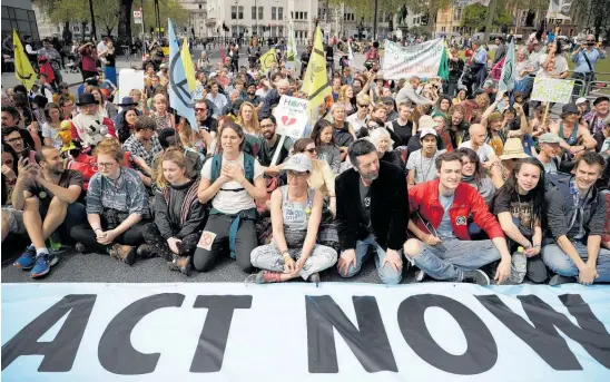  ?? Photo / AP ?? Protesters sit in the road in Parliament Square in London during a climate protest.