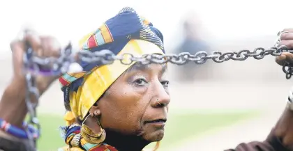  ?? STEVE EARLEY/STAFF ?? Reenactor Ayo Handy-Kendi carries a chain as she represents the slave Angela during the 2019 First African Landing Commemorat­ive Ceremony.