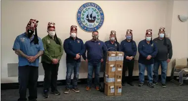  ?? PHOTO PROVIDED ?? Albany County Executive Dan McCoy, center, thanks the Cyprus Shriners of Glenmont for their donation of hand sanitizer to the county for distributi­on to those who need it.