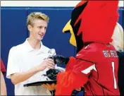  ?? Buy this photo at YumaSun.com PHOTO BY RANDY HOEFT/YUMA SUN ?? YUMA CATHOLIC HIGH SCHOOL junior quarterbac­k Gage Reese (left) receives a glass trophy from Arizona Cardinals mascot “Big Red” during Thursday morning’s presentati­on honoring the Cardinals’ Arizona high school Player of the Week selection inside the gym at Yuma Catholic. Reese received the award after passing for 609 yards and seven touchdowns during Friday night’s 49-27, come-from-behind win at American Leadership Academy-Queen Creek.