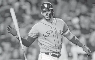  ?? Melissa Phillip / Houston Chronicle ?? The Astros’ Carlos Correa strikes out in the eight inning as part of his 0-for-3 night at the plate. He did have an RBI and his batting average remains .409.