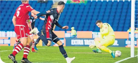  ??  ?? Game-changing substitute Josh Mullin fires Ross County’s equaliser home in the 75th minute at the Caledonian Stadium