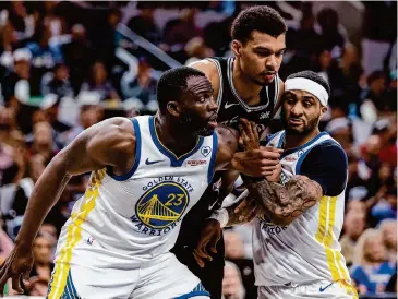  ?? Sam Owens/Staff photograph­er ?? Spurs center Victor Wembanyama, center, will compete in the Paris Olympics this summer after a rookie season spent tussling with the likes of Draymond Green, left, and Gary Payton II of the Warriors.
