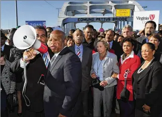  ?? KEVIN GLACKMEYER/AP 2012 ?? U.S. Rep. John Lewis (talking into bullhorn) leads a reenactmen­t of the start of the “Bloody Sunday” march from Selma to Montgomery from the historic Edmund Pettus Bridge on March 4, 2012. This weekend’s Selma Bridge Crossing Jubilee will be the first without Lewis.