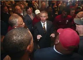  ?? THE ASSOCIATED PRESS ?? FILE - In this Sunday, Dec. 8, 2019, file photo, new Florida State NCAA college football head coach Mike Norvell talks to football staffers after a news conference, in Tallahasse­e, Fla. Norvell is taking over a Seminoles program that has struggled while he was helping to build Memphis into a Group of Five power. Florida State got in three practices before the new coronaviru­s outbreak shut down college sports and upended nearly everything else.