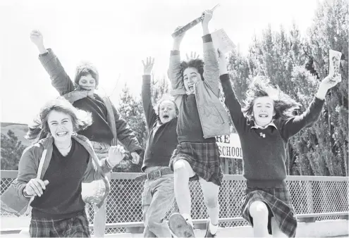  ?? PHOTO: OTAGO DAILY TIMES FILES ?? Kenmure Intermedia­te School, Kaikorai Valley, pupils (from left) Shelly Stevenson, Hamish Skeggs, Keith Howieson, Dale Maitland and Katherine Jones leave school for the last time before the summer holidays in December 1978.