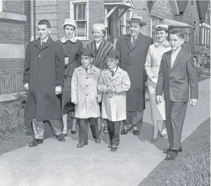  ?? | SUN- TIMES LIBRARY PHOTOS ?? Mayor Richard J. Daley ( center) joins his family for a stroll near his home on South Lowe on Easter Sunday, after church April 1, 1956. From left are Richard M., Mary Carol, John, Eleanor “Sis” Daley, Billy, Eleanor and Michael.