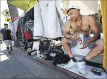  ?? Genaro Molina Los Angeles Times ?? VASILIS SAKELLARID­IS sips Gatorade while trying to cool off at his encampment along Selma Avenue in Hollywood on Sept. 3.