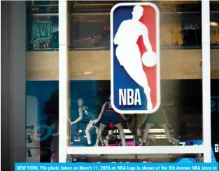  ??  ?? NEW YORK: File photo taken on March 11, 2020 an NBA logo is shown at the 5th Avenue NBA store in New York City. The NBA informed clubs that it plans to allow individual workouts by players at team facilities no sooner than May 8 in areas where allowed by government regulation­s.