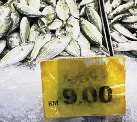  ??  ?? Rising prices: A file picture showing fish for sale at a wet market in Johor Bahru. Higher prices in 10 main groups led to a 2.7% growth in CPI in January. — Reuters