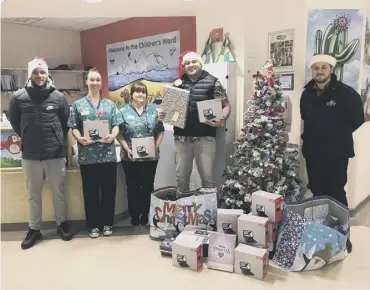  ?? PHOTO SUBMITTED ?? DELIGHT: Calderdale Hospital staff with ALB directors Arran Bailey, second right, and Harry Whyte, right.