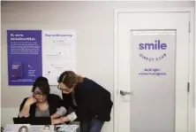  ?? AP PHOTO/JAE C. HONG ?? In 2019, dental assistants go over appointmen­ts at SmileDirec­tClub’s SmileShop inside a CVS store in Downey, Calif.