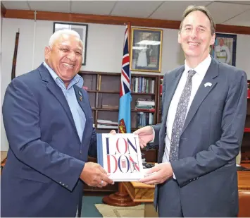  ?? Photo: Ministry of Foreign Affairs ?? Prime Minister Voreqe Bainimaram­a while receiving a token of appreciati­on from the new British High Commission­er to Fiji, Christophe­r George Edgar.