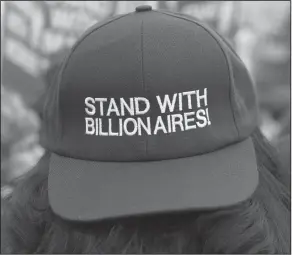  ?? AP Photo/Jacquelyn Martin ?? Protest: Wearing a "stand with billionair­es" hat, a union supporters counter-protests inside the anti-union fees section as supporters and opposers rally outside of the Supreme Court, Monday in Washington. The Supreme Court takes up a challenge in a...