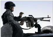  ?? RAHMAT GUL / ASSOCIATED PRESS ?? An Afghan security offifficer stands guard Tuesday after
clashes with Taliban fifighters at an intelligen­ce facility in Kabul. One person was killed and three were wounded, including a NATO soldier.