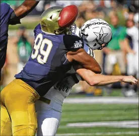  ?? PHOTOS BY JONATHAN DANIEL / GETTY IMAGES ?? Notre Dame’s Jerry Tillery hits Vanderbilt quarterbac­k Kyle Shurmur to force a fumble on Saturday. The Irish won 22-17.