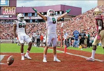  ?? AL DIAZ / MIAMI HERALD ?? Wide receiver Braxton Berrios (8, celebratin­g his 6-yard touchdown reception in the third quarter against Florida State on Saturday) was a key player in Miami’s victory over its in-state nemesis.