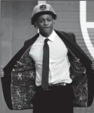  ?? YONG KIM/TRIBUNE NEWS SERVICE ?? De'Aaron Fox shows off his coat after the Sacramento Kings selected him with the fifth pick of the 2017 NBA Draft at the Barclays Center in Brooklyn, New York, on Thursday.