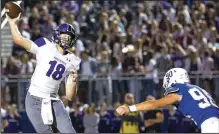  ?? Special to NWA Democrat-Gazette/DAVID BEACH ?? Hank Gibbs (left) of Fayettevil­le throws the ball Friday as he is pressured by Ben Carrillo of Rogers at Whitey Smith Stadium in Rogers.